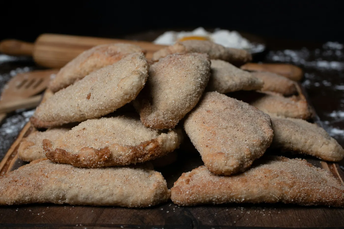 A pile of pastries dusted heavily with cinnamon sugar