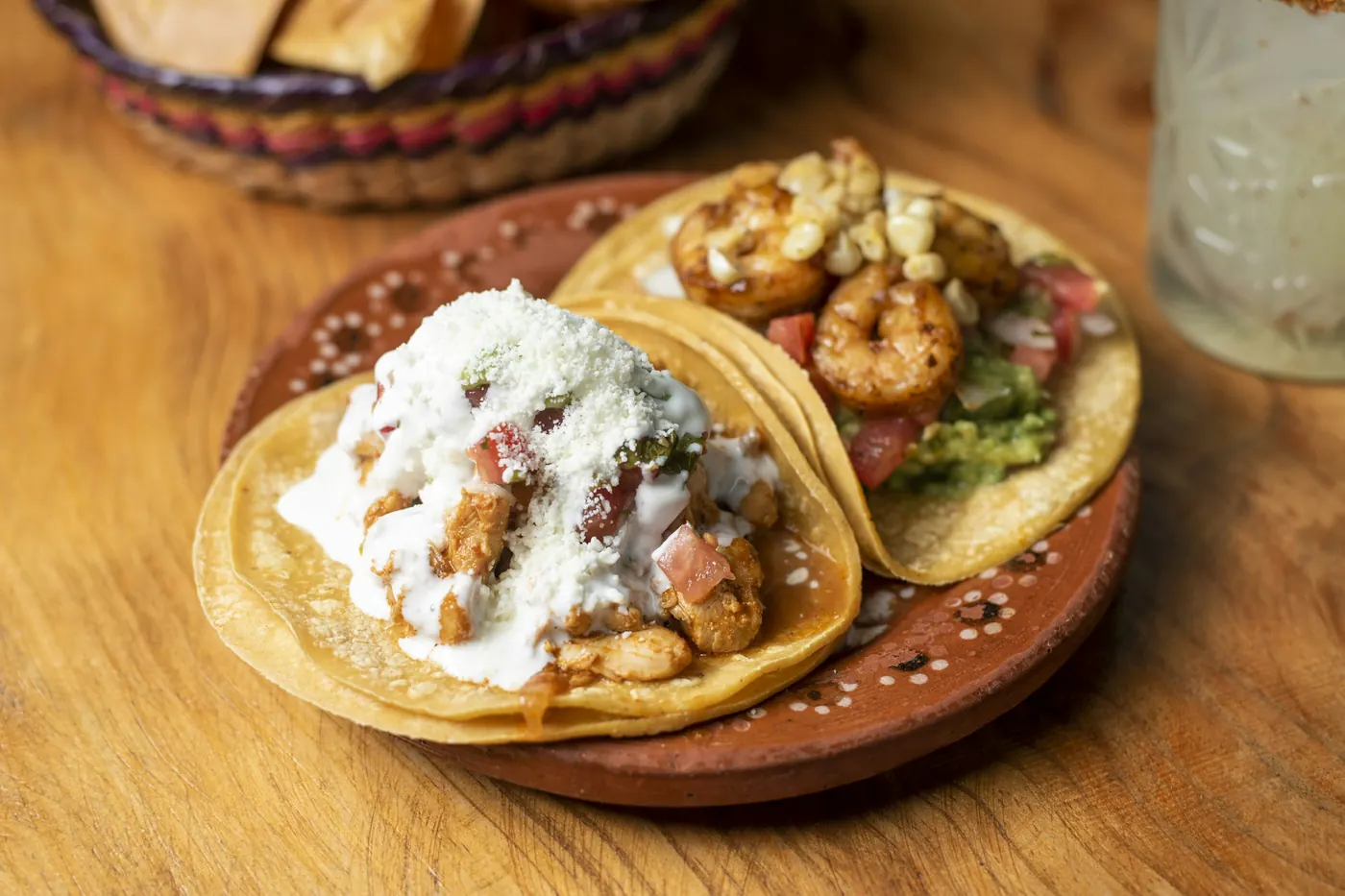 Soft tacos finished with crema and crumbled white cheese