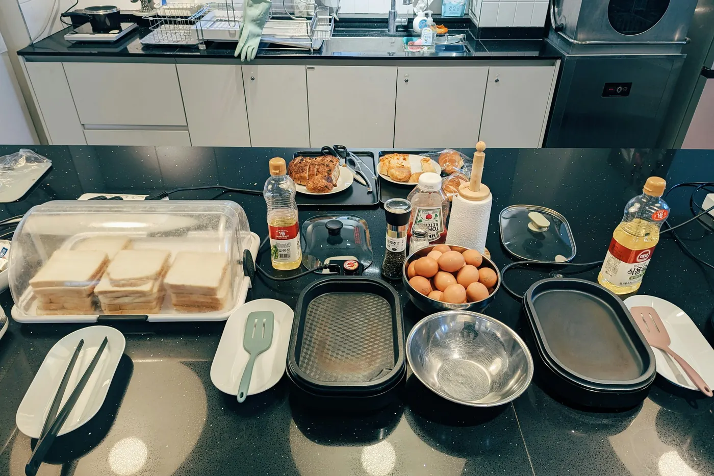 Takeout containers and boxes of food spread across a kitchen counter