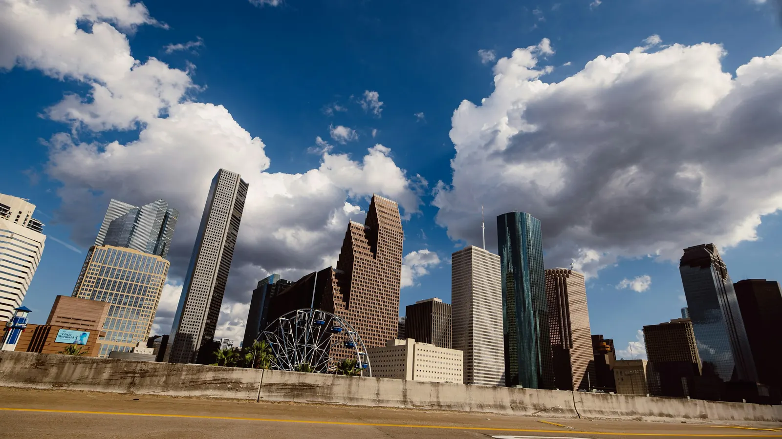 The downtown Houston skyline under a bright cloudy sky