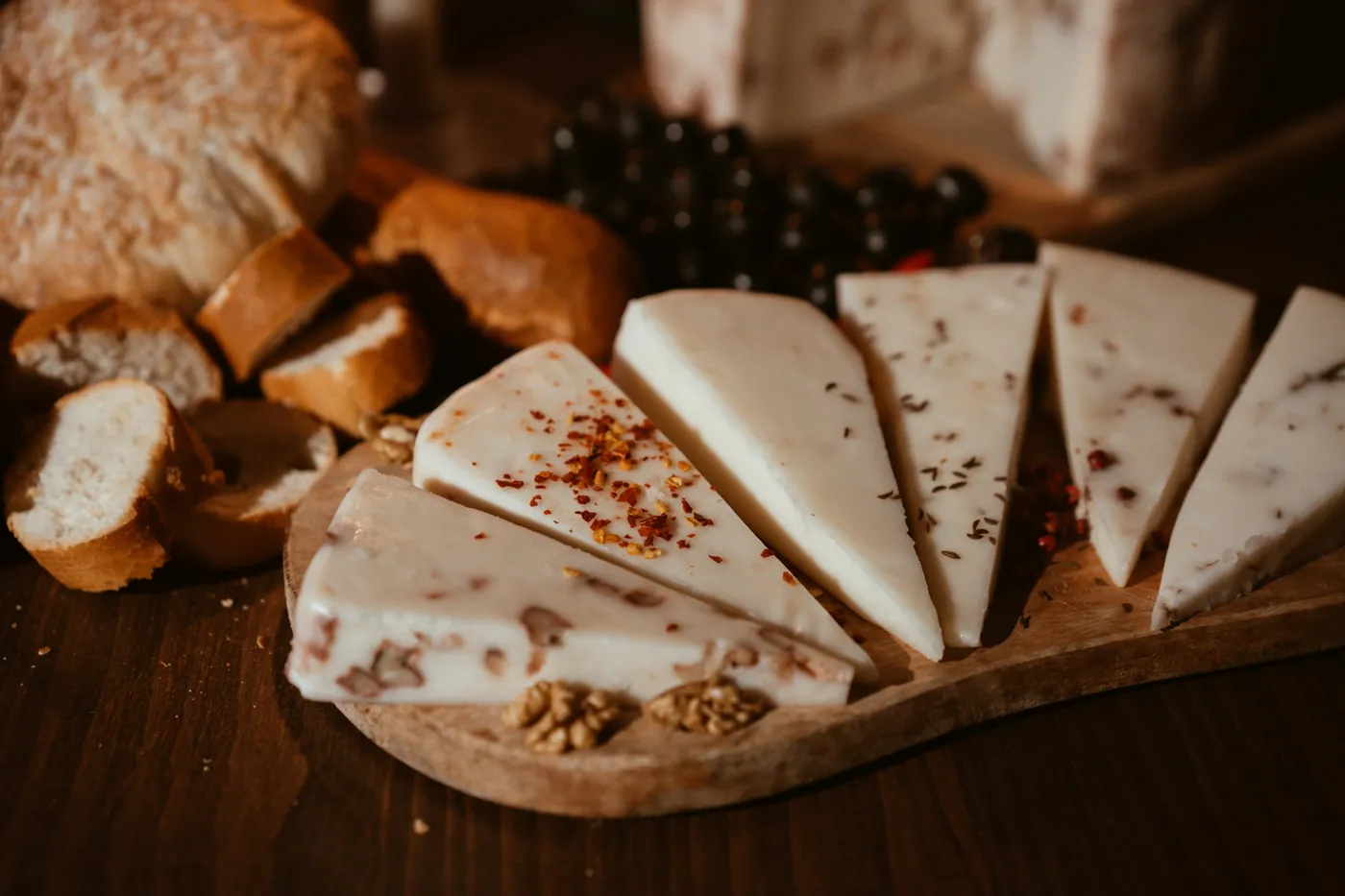Wedges of pale Mexican melting cheese on a wooden board