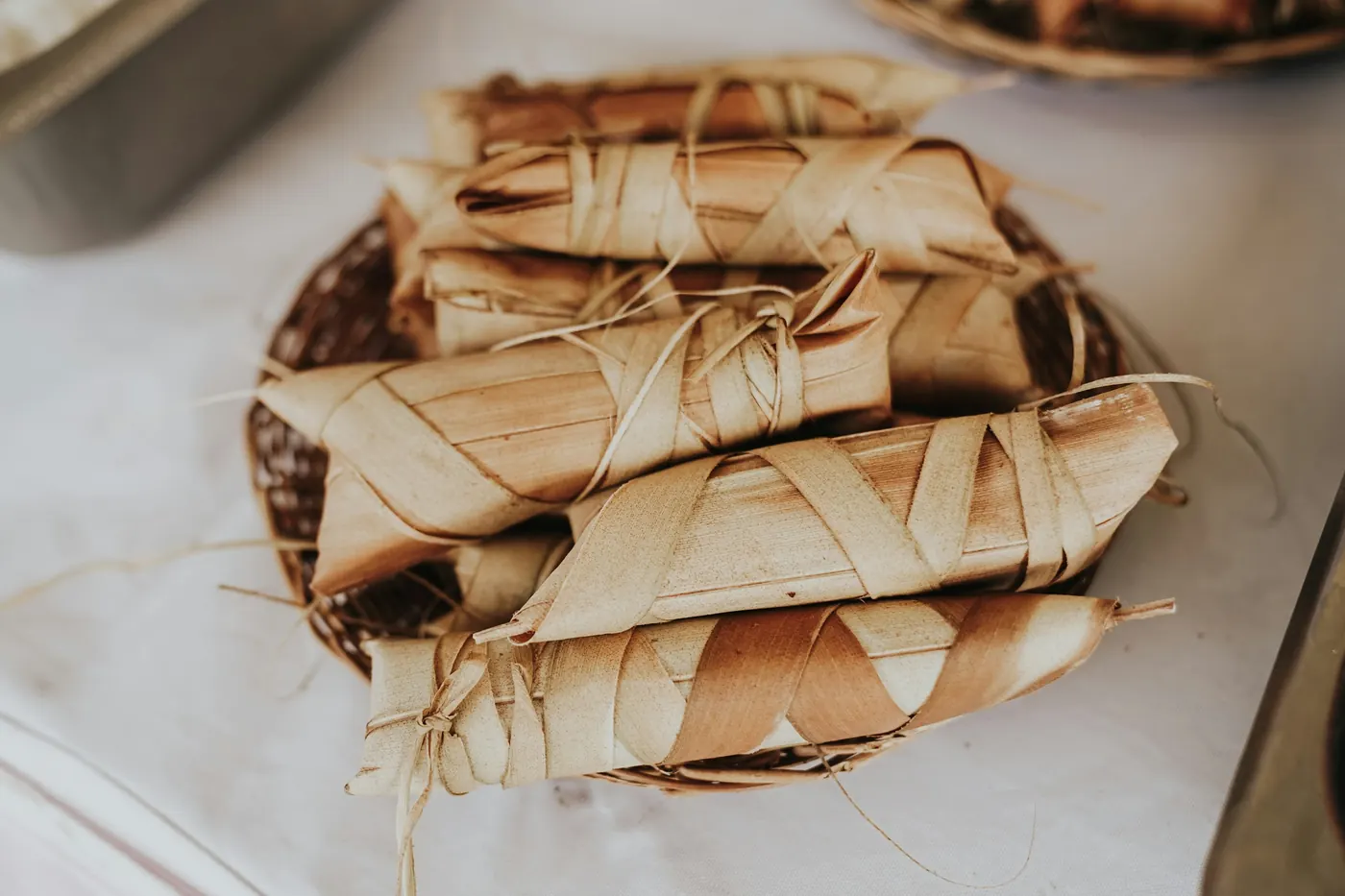 Wrapped tamales served on a plate ready to be opened